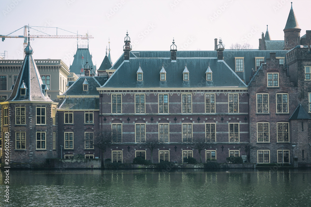 View of the Hofvijver / Court Pond adjoined by museum Mauritshuis and the Binnenhof (Inner court) housing the States General and the Prime Minister of The Netherlands in The Hague, The Netherlands. 