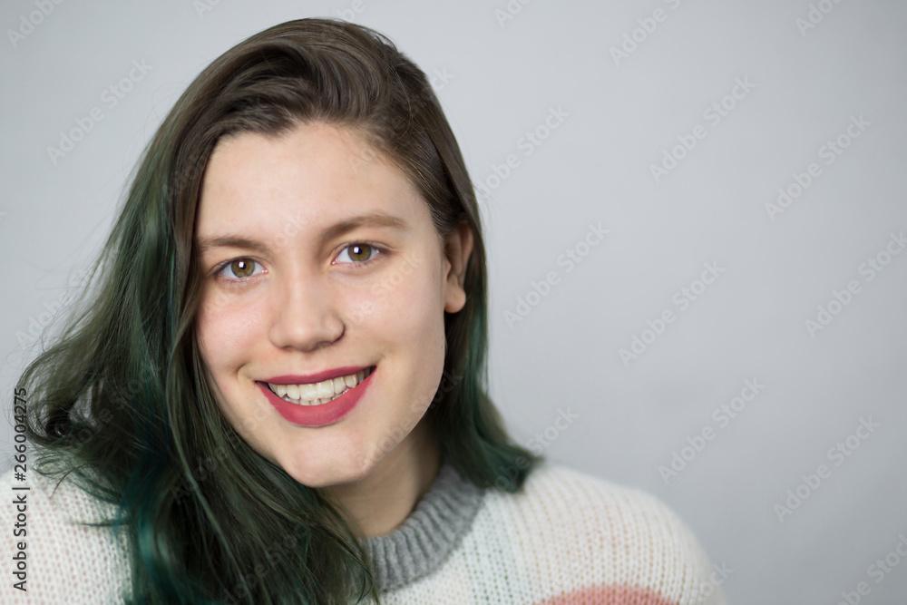 Beautiful brunette girl with dyed green hair on white background. Beautiful brunette girl with dyed green hair on white background.