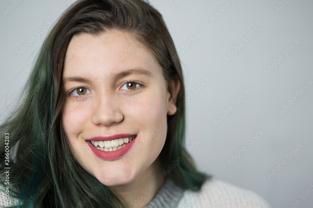 Beautiful brunette girl with dyed green hair on white background. Beautiful brunette girl with dyed green hair on white background.