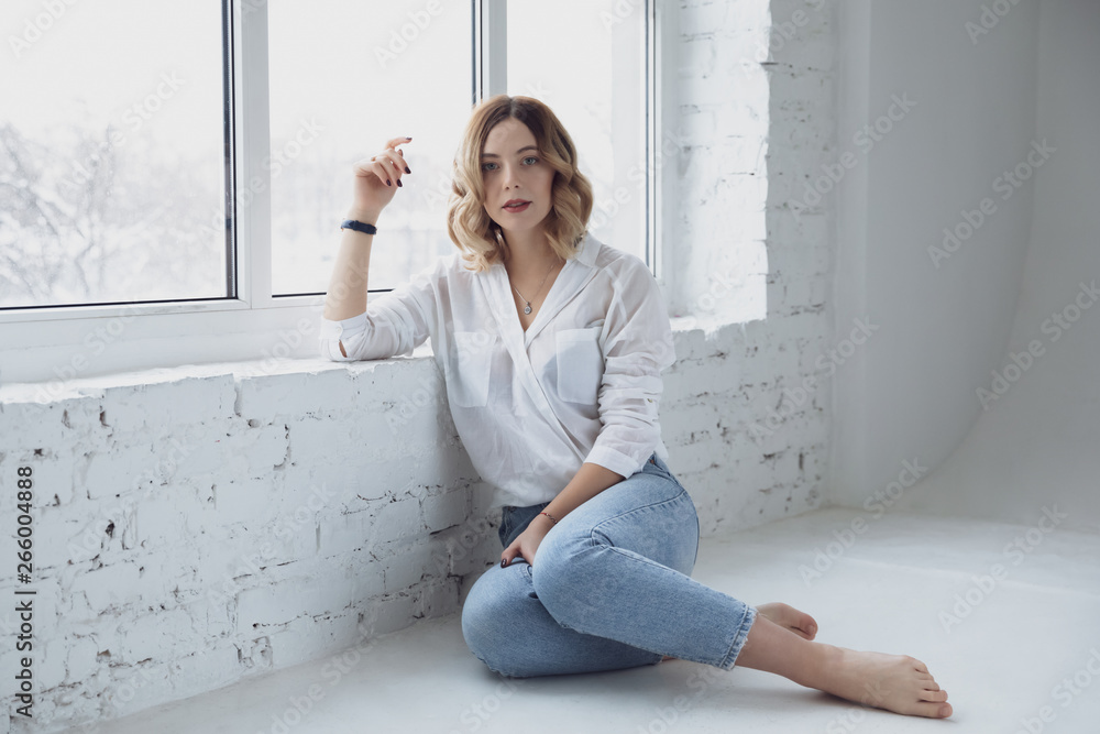 Beautiful girl on white wall background. Shooting in the studio. Beautiful girl on white wall background. Shooting in the studio.