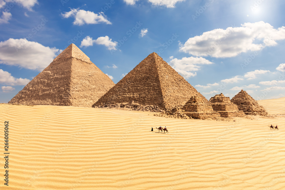 The Pyramid of Chephren, the Pyramid of Menkaure and its companions in the sands of Giza desert, Egypt The Pyramid of Chephren, the Pyramid of Menkaure and its companions in the sands of Giza desert, Egypt