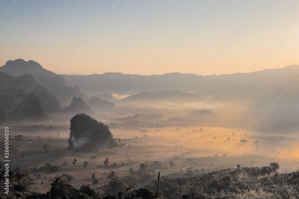 sunrise at Phu Langka Photo Corner View Point, view sea of mist in valley with the hills and yellow sun light in the sky background, Phu Langka Route 1148, Phayao, northern of Thailand.