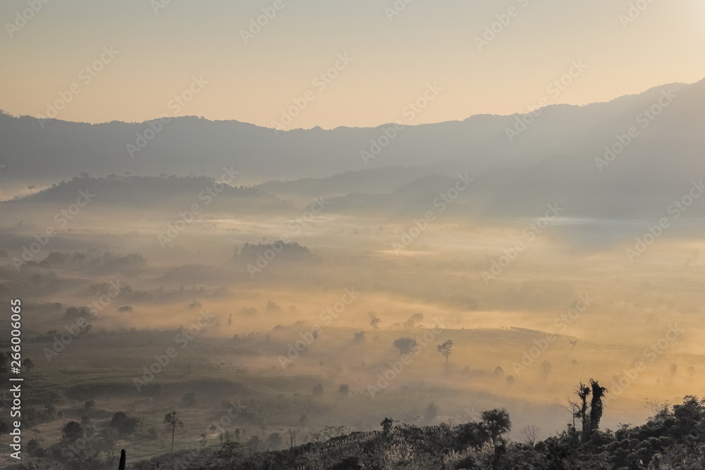 sunrise at Phu Langka Photo Corner View Point, view sea of mist in valley with the hills and yellow sun light in the sky background, Phu Langka Route 1148, Phayao, northern of Thailand.