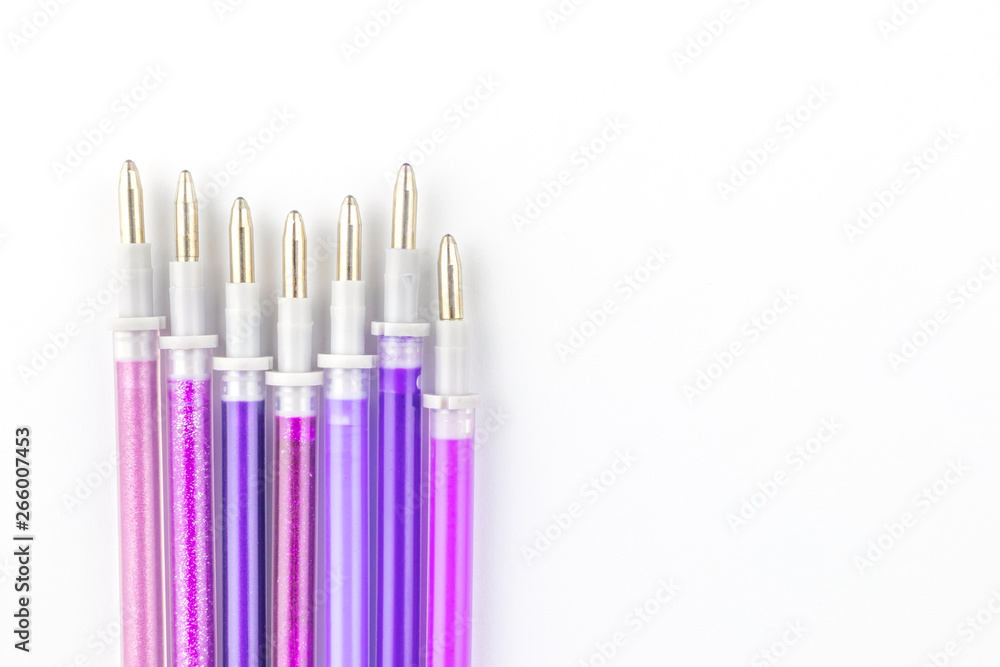 Gel paste for pens of purple and lilac shades on a background of white paper. The concept of stationery for school, business and creative. Gel paste for pens of purple and lilac shades on a background of white paper. The concept of stationery for school, business and creative.