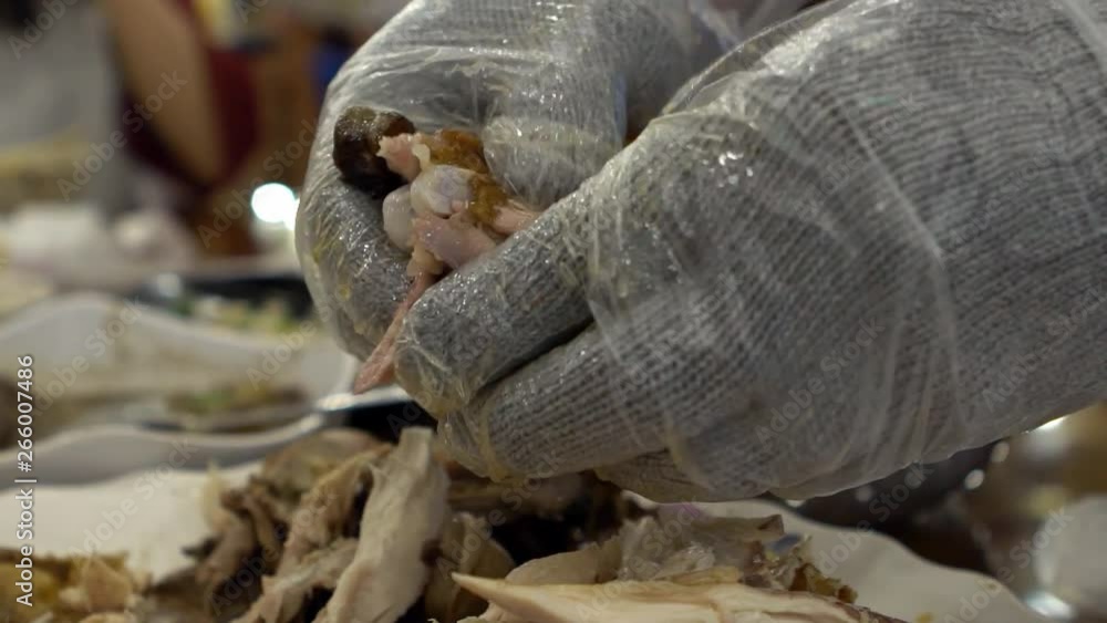 Slow Motion of chef hands preparing traditional chicken food at restaurant of Taiwan mountain. Famous roasted chicken in clay oven. Asian man using hands with gloves to cut parts of food for eat.-Dan Slow Motion of chef hands preparing traditional chicken food at restaurant of Taiwan mountain. Famous roasted chicken in clay oven. Asian man using hands with gloves to cut parts of food for eat.-Dan
