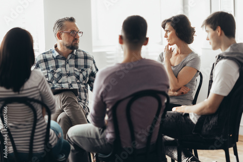 Woman talking to professional psychotherapist in support group for ACOA photo