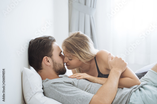 Young couple kissing in the bed .loving couple in bedroom