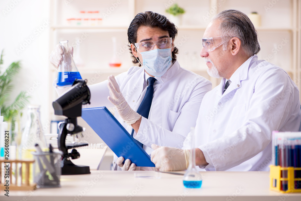 Two chemists working in the lab Two chemists working in the lab