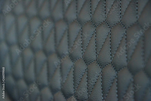 Perforated leather seat texture in modern car close
