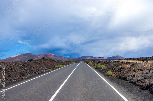 Road to Timanfaya with a storm in the background, over the volcanoes
