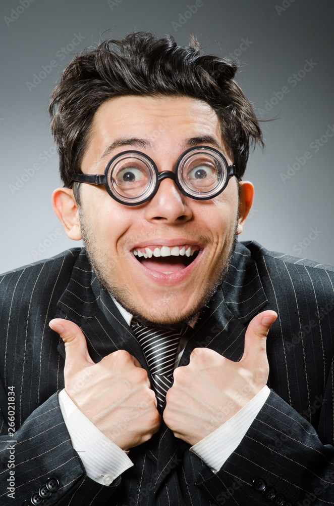 Fotografie Funny nerd businessman in dark studio