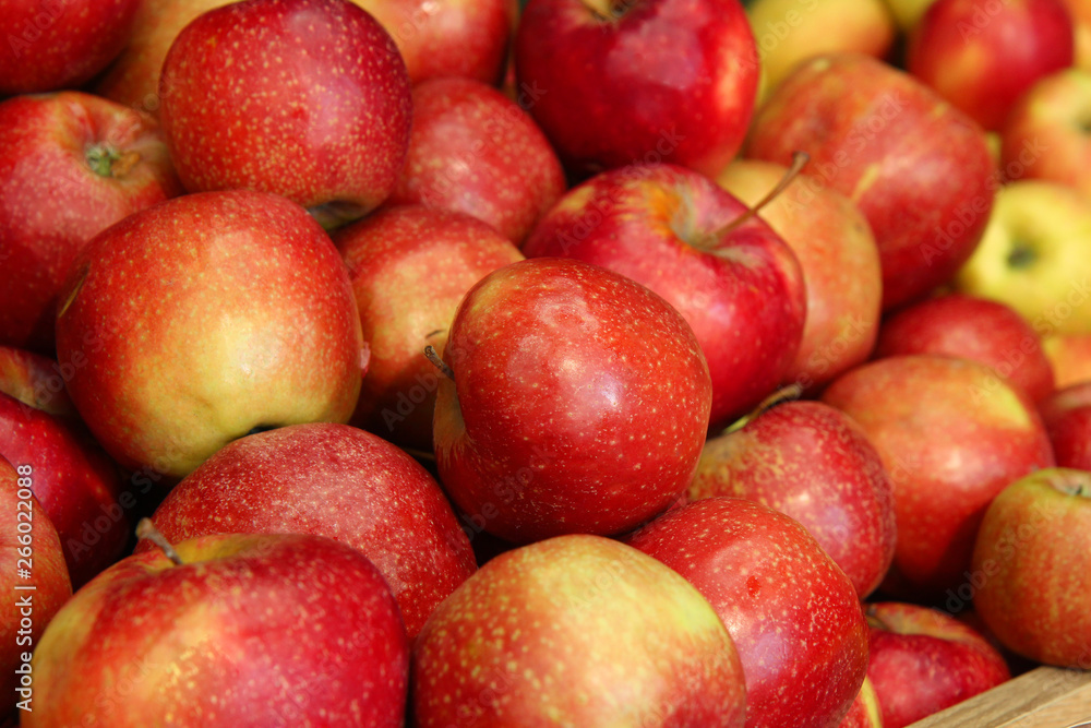 Red apples as background. Pile of red apples. Red apples on wooden table Red apples as background. Pile of red apples. Red apples on wooden table