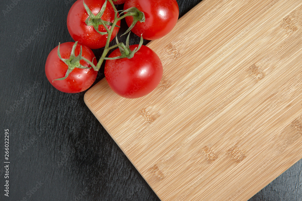 tomatoes and knife on cutting Board on dark background tomatoes and knife on cutting Board on dark background