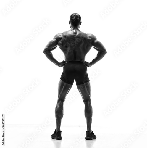 Black and White image of Strong Muscular Men Flexing Muscles from the Back. He is showing back muscles development © mrbigphoto