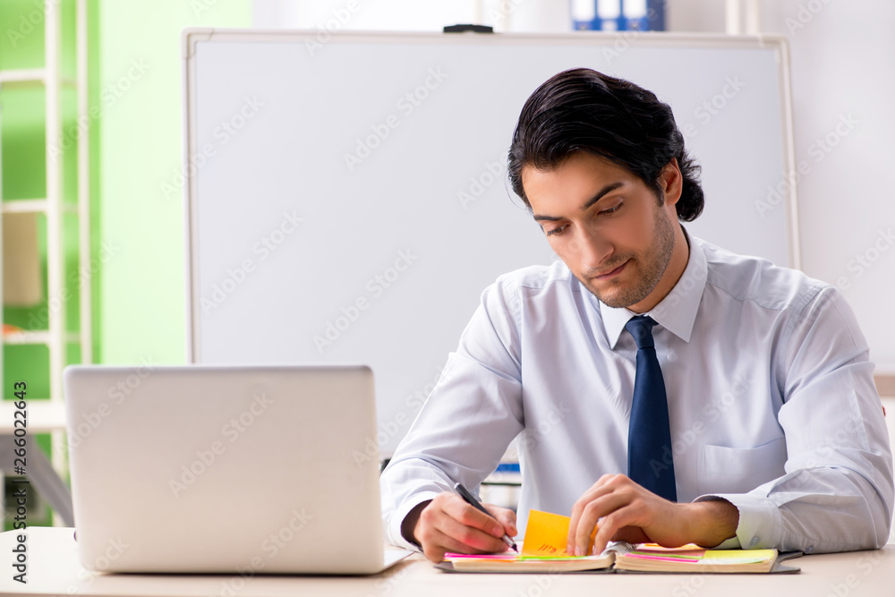 Young handsome financial speciaist in front of white board Young handsome financial speciaist in front of white board