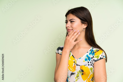 Teenager girl with floral dress thinking an idea