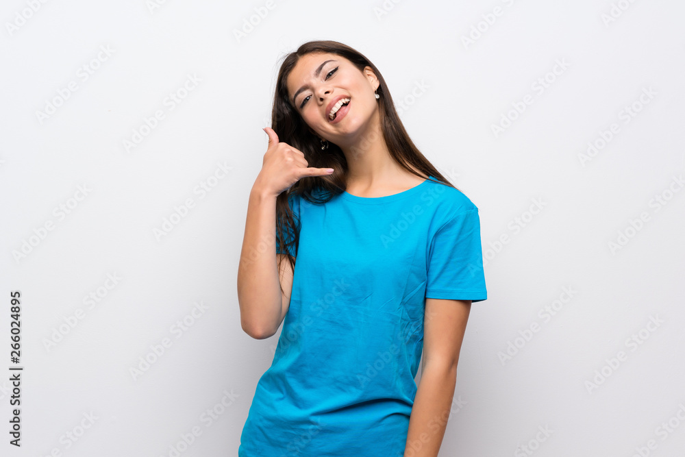 Teenager girl with blue shirt making phone gesture. Call me back sign Teenager girl with blue shirt making phone gesture. Call me back sign