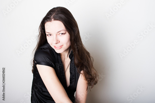 Young friendly brunette smiling. Portrait of a young confident woman,