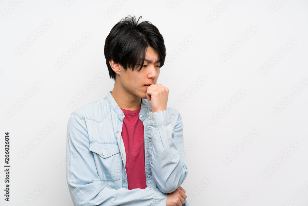 Asian man on isolated white background having doubts Asian man on isolated white background having doubts
