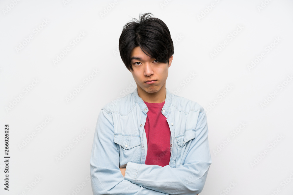 Asian man on isolated white background with sad and depressed expression Asian man on isolated white background with sad and depressed expression