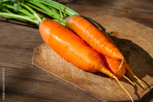 raw ripe carrots on wooden table