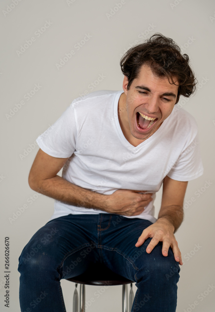 Positive and joyful young funny man in his twenties hard laughing and having fun Positive and joyful young funny man in his twenties hard laughing and having fun