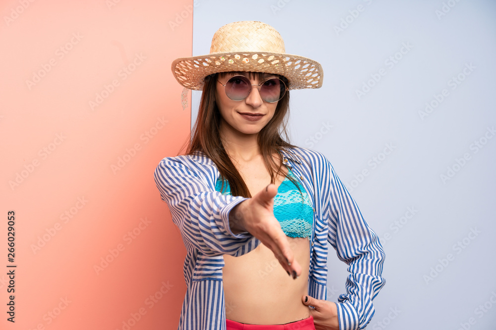 Young woman in bikini handshaking after good deal