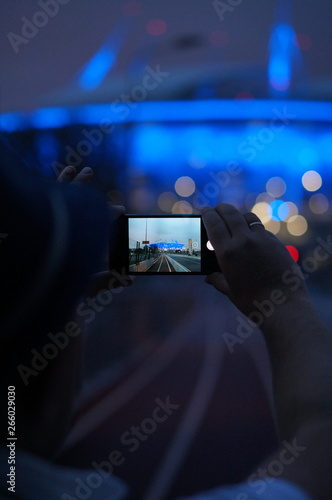 A man photographs the new stadium Zenit Arena in St. Petersburg, Russia.