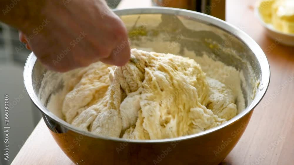 Kneading dough with spoon. Process of preparation food, baking bread or making pastry. Concept of home cooking Kneading dough with spoon. Process of preparation food, baking bread or making pastry. Concept of home cooking