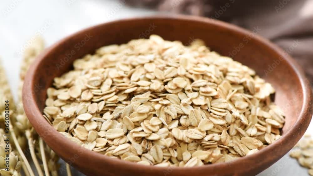 Oats, Rolled oats or oat flakes in bowl. Healthy eating, dieting, weight loss food concept. Closeup view. Oats, Rolled oats or oat flakes in bowl. Healthy eating, dieting, weight loss food concept. Closeup view.