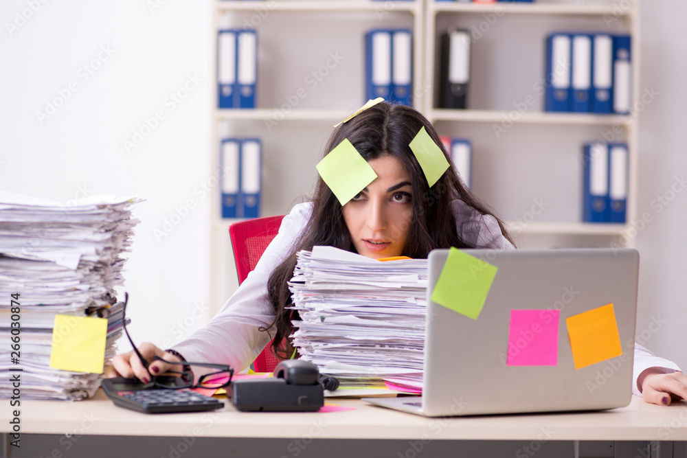 Young female employee in conflicting priorities concept Young female employee in conflicting priorities concept