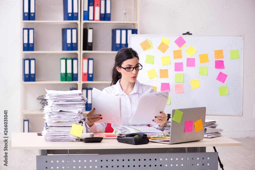 Young female employee in conflicting priorities concept Young female employee in conflicting priorities concept