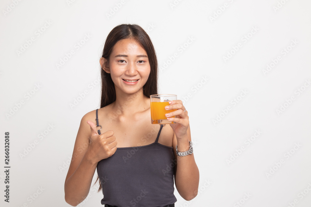 Young Asian woman thumbs up drink orange juice. Young Asian woman thumbs up drink orange juice.