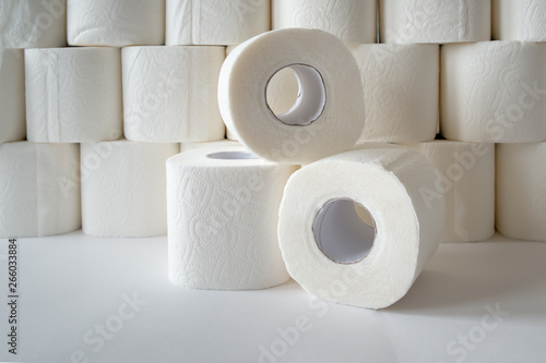 three rolls of toilet paper on toilet paper background
