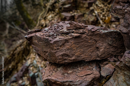 Red and blue cracked rock closeup , with blur background photo