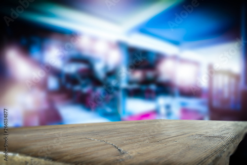 Table background of free space for your decoration and blurred bar. Night Club interior. 