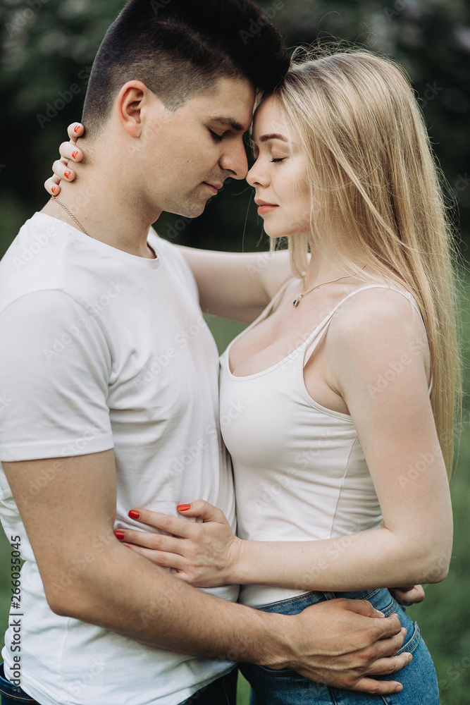 A romantic couple in love hugging and looking at each other outdoors A romantic couple in love hugging and looking at each other outdoors