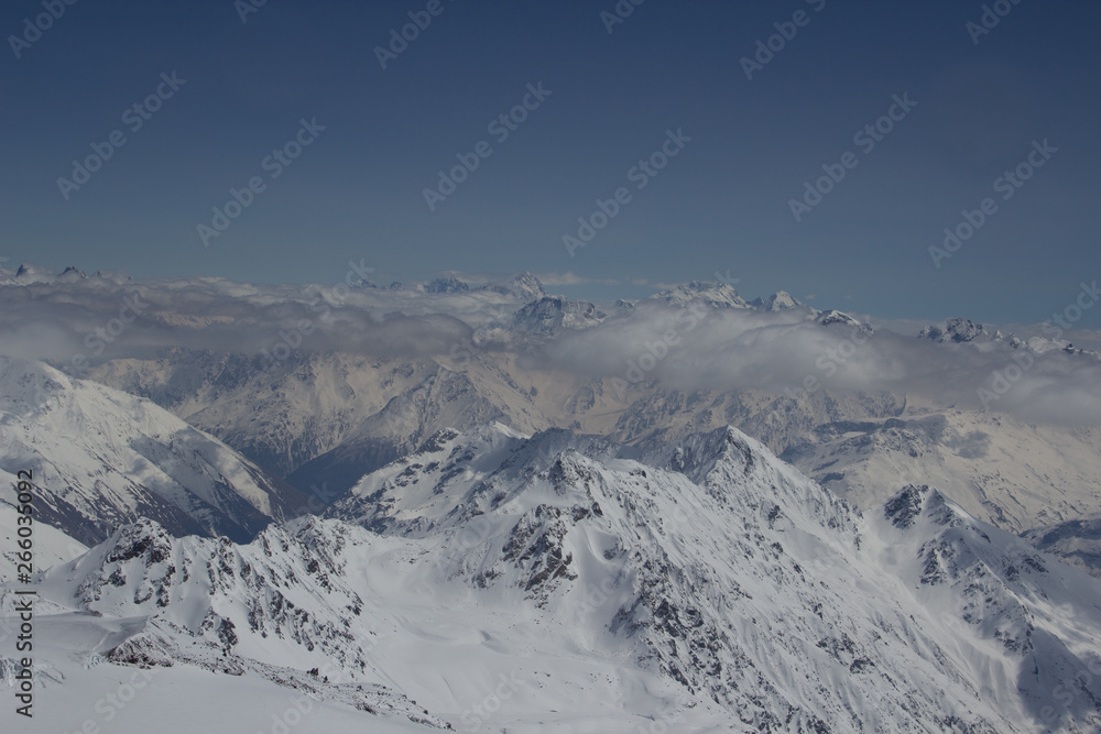 Above the clouds. Snow Great Caucasus mountain range. Ushba on a Sunny winter's day. Kabardino-Balkaria, Russia
