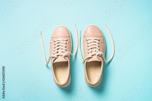 Woman fashion pink shoes on blue background.