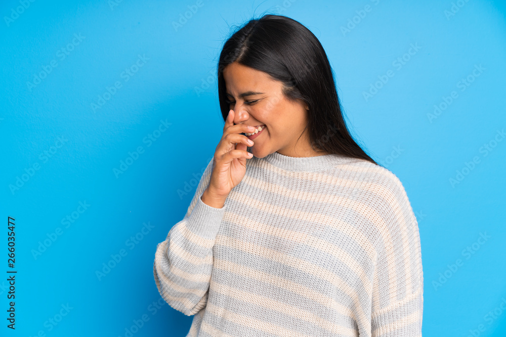 Young Colombian girl with sweater laughing Young Colombian girl with sweater laughing
