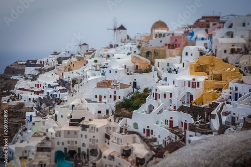Tilt shift effect of houses in the village of Oia on a cloudy day