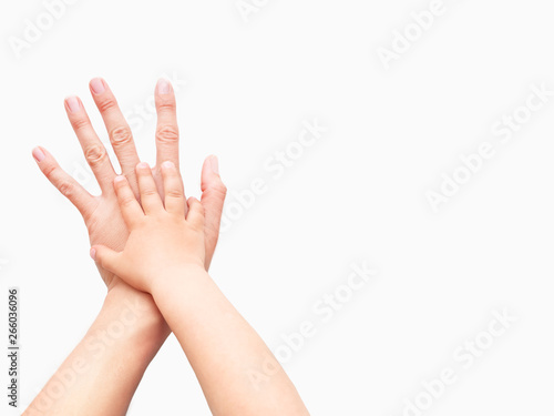 Hands of adult and child. Mother and kid put their palms together on white background. Parent and toddler. Symbol of family, unanimity, support.