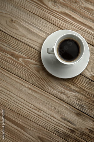 Hot coffee on a wooden stand, top view