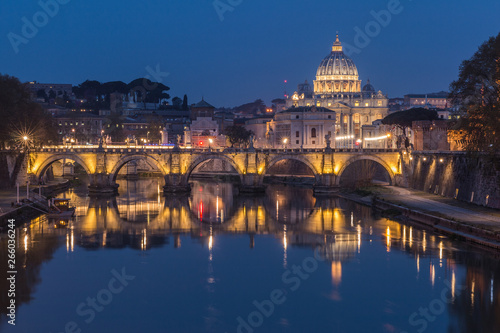 Tiber and St Peters Basilica with Aurelius Bridge or Ponte Sisto Bridge at the blue hour with lighting and reflections. Stone bridge over river Tiber in the historic center of Rome © Marco