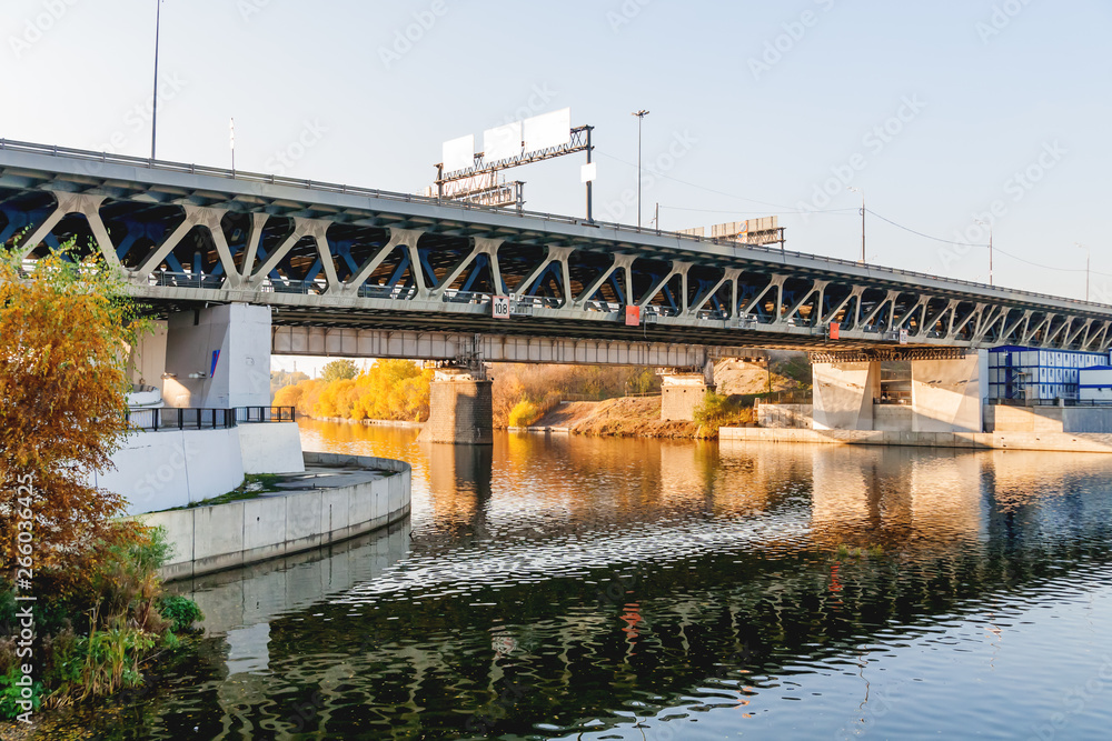 Old Dorogomilovsky railway bridge and Third Ring Road. Autumn cityscape with transport infrastructure and Moscow-river. View from Taras Shevchenko embankment, Moscow, Russia.