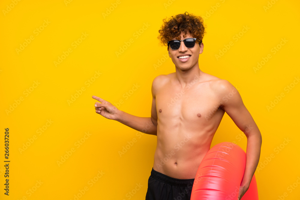 African american man over isolated purple wall pointing finger to the side African american man over isolated purple wall pointing finger to the side