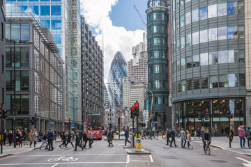 London, UK.  City of London busy street with view  with lots of people crossing the road, cars and buses 