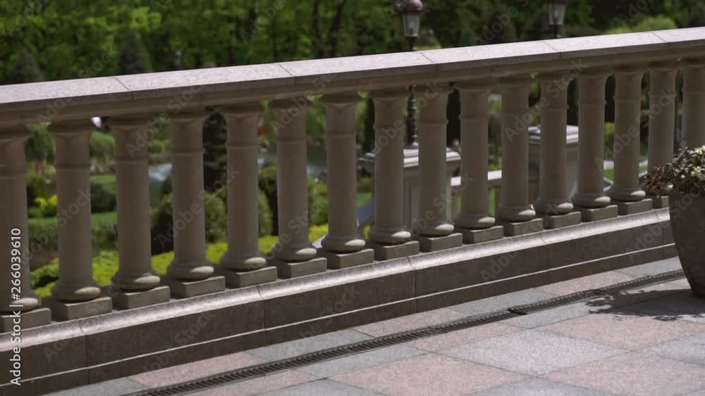 Railings in the form of balustrades in a public park on a sunny day. Close-up. Exterior of the ornamental garden. Classic architecture Railings in the form of balustrades in a public park on a sunny day. Close-up. Exterior of the ornamental garden. Classic architecture