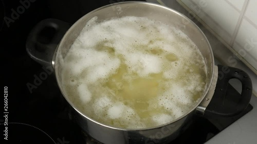 Wallpaper Mural Close up. Women's hands remove the foam from the pot with boiled potatoes. Torontodigital.ca