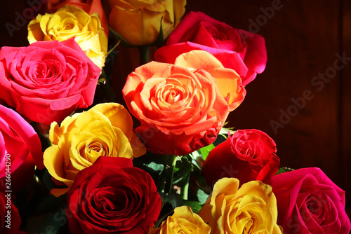 Floral background with colorful roses. Bunch of bright colors roses close up. 